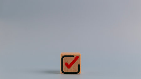 Wooden cube with a checkmark icon. Goals achievement and business success. Task completion. Ethical corporate. Do the right thing. Quality and ISO symbol.の写真素材