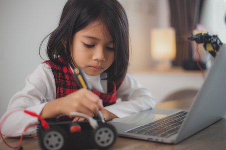 STEM education concept. Asian students learn at home by coding robot arms in STEM, mathematics...