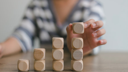 Businesswomen stack blank wooden cubes on the table with copy space, empty wooden cubes for input...