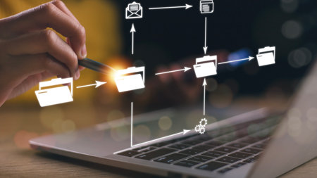 DMS Document Management System is being set up by an IT consultant working on a laptop computer in...