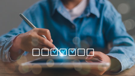 Checklist concept. Businessman using tablet. Checking marks on checkboxes on the futuristic virtual interface screen.の写真素材