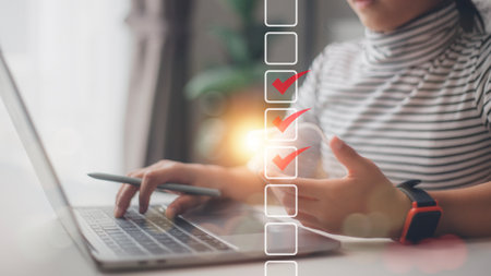 Checklist concept. Businesswoman using a laptop. Checking marks on checkboxes on the futuristic...
