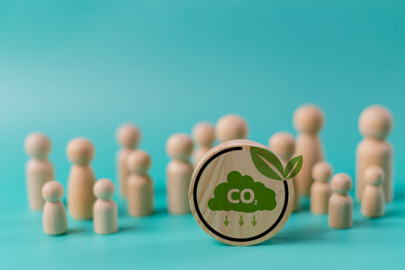 A group of people are gathered around a wooden circle with the word CO2 on it. Scene is one of...