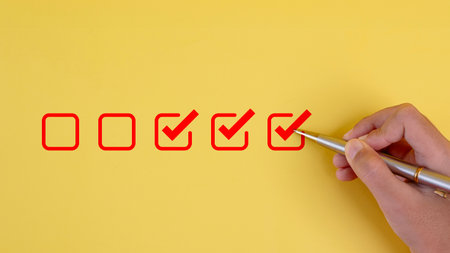 pens to tick the correct sign mark in the checkbox for the quality document control checklist and business approves project concept.の写真素材