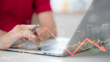Economic crisis, financial background. currency with financial graph chart falling due to global economic recession, stock market crash, inflationの写真素材