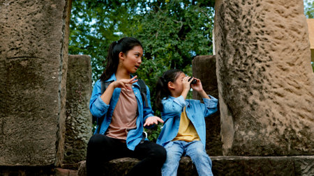 Two Asian siblings explore the Phnom Wan Stone Castle, admire the ancient architecture and take photos to record their memories.の写真素材