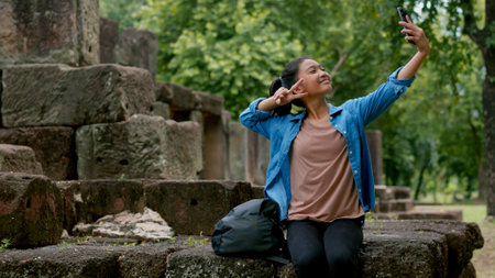 An Asian woman explores the Phanom Wan Stone Castle and takes photos of the impressive sight.の写真素材