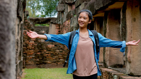 An Asian woman explores the Phanom Wan Stone Castle and takes photos of the impressive sight.の写真素材