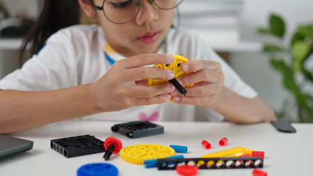 STEM education concept. Asian home school girls self-study online lessons and are excited to make STEM toys. mathematics engineering science technology computer code in robotics for kids' concepts.の写真素材