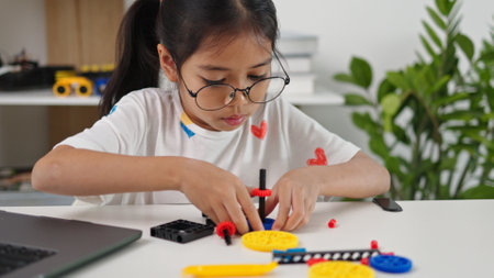 STEM education concept. Asian home school girls self-study online lessons and are excited to make STEM toys. mathematics engineering science technology computer code in robotics for kids' concepts.の写真素材