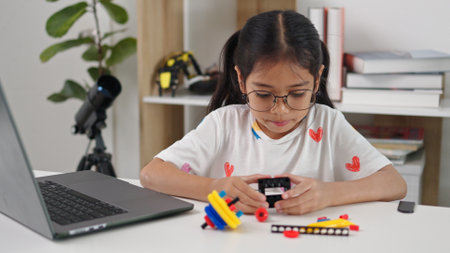 STEM education concept. Asian home school girls self-study online lessons and are excited to make STEM toys. mathematics engineering science technology computer code in robotics for kids' concepts.の写真素材