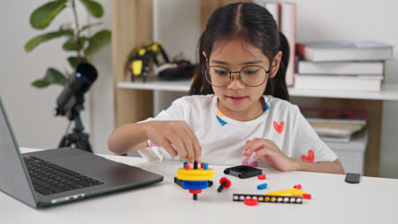 STEM education concept. Asian home school girls self-study online lessons and are excited to make STEM toys. mathematics engineering science technology computer code in robotics for kids' concepts.の写真素材
