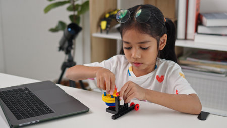 STEM education concept. Asian home school girls self-study online lessons and are excited to make STEM toys. mathematics engineering science technology computer code in robotics for kids' concepts.の写真素材