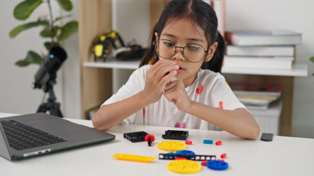 STEM education concept. Asian home school girls self-study online lessons and are excited to make STEM toys. mathematics engineering science technology computer code in robotics for kids' concepts.の写真素材