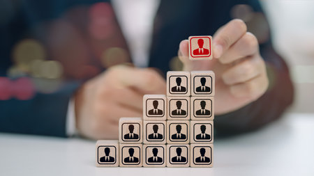 Business hiring and recruitment selection. Employee lead choice. Career opportunity. Human Resource Management idea. HR or Manager hand picking person or candidate icons on stack wooden cube blocks.の写真素材