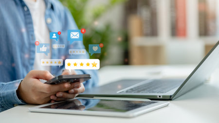 Customer review good rating concept, A man using a smartphone to give a 5-star customer review. positive customer feedback, testimonials and testimony, user comments, and feedback for review.の写真素材