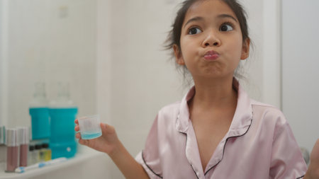 Asian cute girl to rinse your mouth after brushing your teeth, health care conceptの写真素材