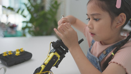 Robotics programming class. Children construct and code Robots. STEM education using constructor blocks and laptop, remote control joystick. Technology educational development for school kidsの写真素材