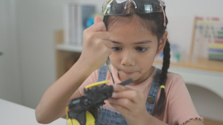 Robotics programming class. Children construct and code Robots. STEM education using constructor blocks and laptop, remote control joystick. Technology educational development for school kidsの写真素材