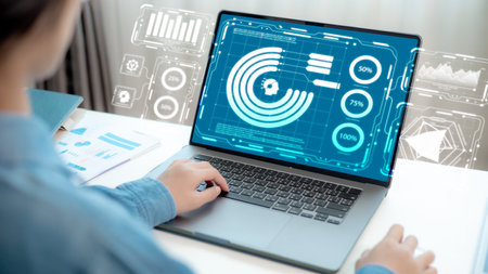 Businessman analyzing marketing strategy and performance data using a futuristic dashboard on the laptop screenの写真素材