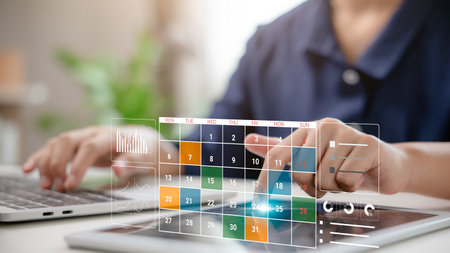 A person using a digital calendar to manage schedule and plan weekly tasks on a smart deviceの写真素材