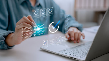 Business user interacting with digital checklist interface on virtual screen, symbolizing productivity, task management, online project planning, and digital workflow in modern workspace.の写真素材