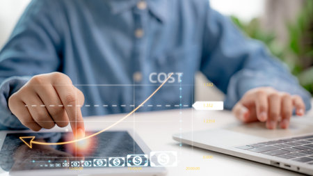 Business hand analyzing digital cost graph on tablet, showing data visualization and strategy for cost reduction and financial efficiency using smart technology.の写真素材