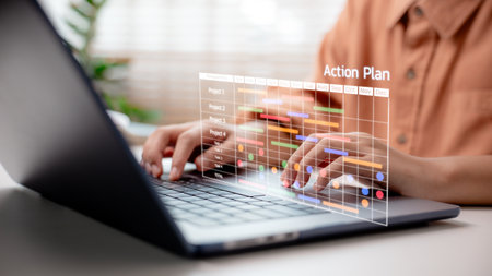 Businessperson managing project timeline on laptop with digital Gantt chart and "Action Plan" label, representing strategic execution, project scheduling, and task tracking in business planning systems.の写真素材