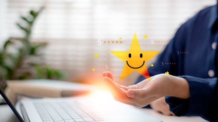 Hand showing five-star rating with smiling star icon, representing excellent customer feedback, satisfaction score, service quality, review, and positive experience.の写真素材