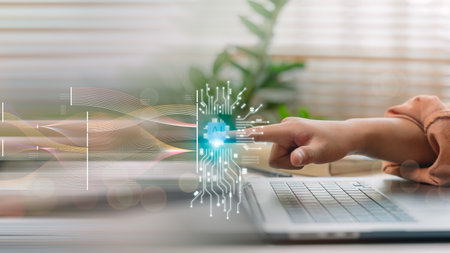 Finger activating AI interface on laptop with flowing data visualization, representing artificial intelligence, machine learning, data processing, neural networks, and smart computing technology.の写真素材