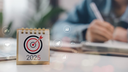 Goal target icon on 2025 calendar with business strategy symbols. Concept of planning, vision, new...