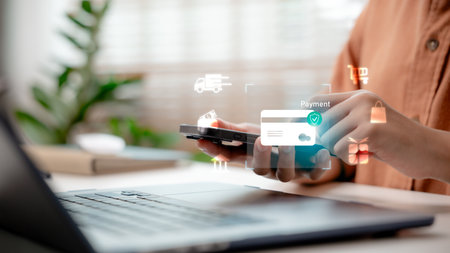 Online payment via smartphone with credit card hologram icons. Digital finance, fintech transactions, secure e-commerce checkout, mobile shopping, and contactless payment.の写真素材
