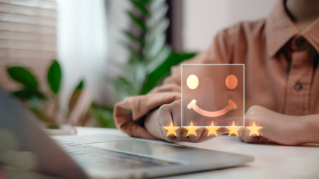 Hand pointing at virtual five-star rating with smiling face icon on digital interface. Concept of customer satisfaction, positive review, service quality, user feedback, and online reputation.の写真素材