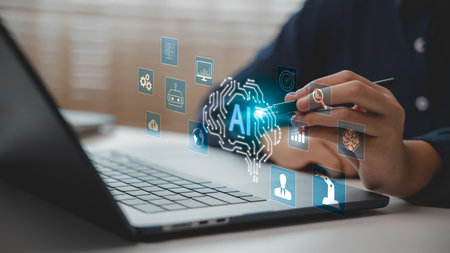 Close-up of hand using stylus with AI interface on laptop screen. Concept of artificial intelligence ecosystem, machine learning, automation, data analytics, and smart digital transformation.の写真素材