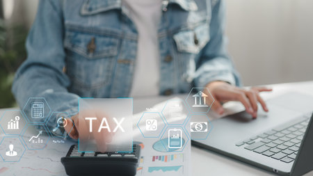 Person calculating tax on digital platform with financial icons overlay. Concept for online tax filing, business finance planning, digital accounting, percentage calculation, and modern financial tech.の写真素材