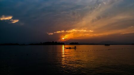 sunset over the river and boatの写真素材