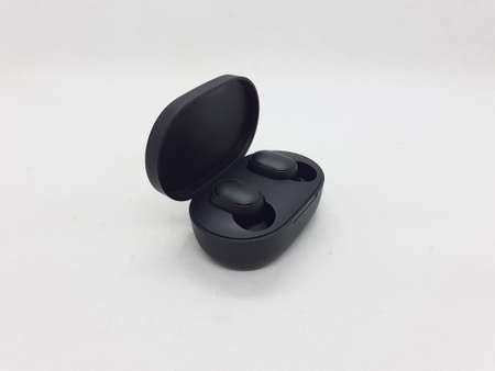 a pair of black cordless earbuds on  white isolation background