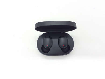 a pair of cordless black ear buds on white isolation background
