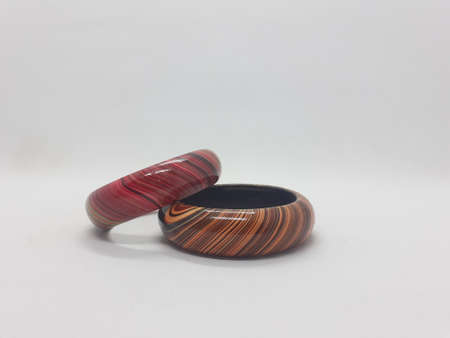brown and red pair of bracelet on white isolation background