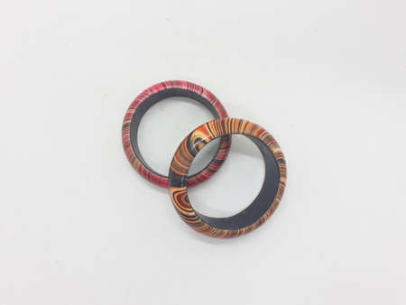 brown and red pair of bracelet on white isolation background