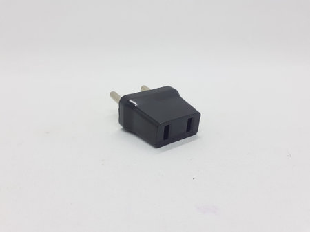 a black electrical plug adaptor on white isolation background