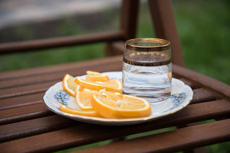 vodka and oranges at the plate on the stoolの写真素材