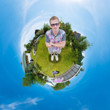 man standing on the grass in the garden, and the whole world is ball