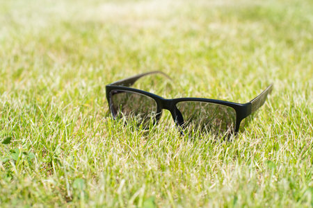 sunglasses lie on the very green grassの写真素材