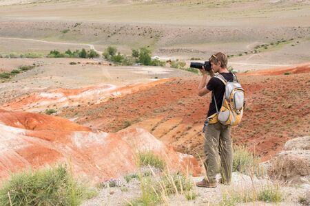 a photographer with a backpack photographed in the mars mountainsの写真素材