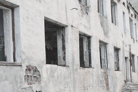 White wall of an abandoned building. Broken windowsの写真素材