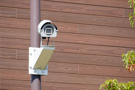 Surveillance camera or security camera on the wall of the house