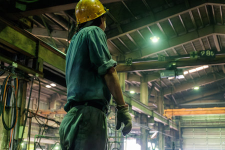 Rear view of factory and men in work clothes.の写真素材
