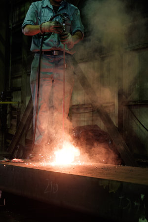 Worker is welding steel in the factory, closeup of photo