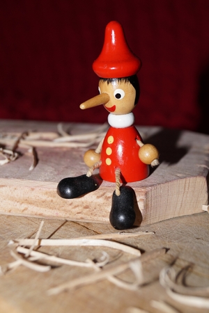 Background with Pinocchio wooden doll and wood chipsの写真素材